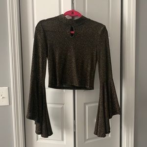 Midriff blouse. Size M. 60% nylon 35% metallic 5% spandex.
